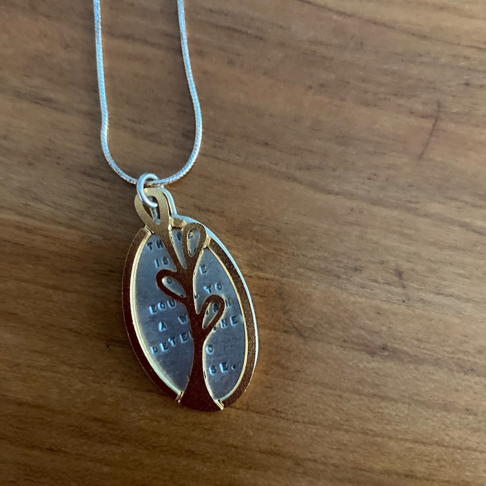 Sterling silver and 22 karat gold pendant necklace. Gold tree, silver medallion.